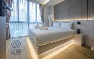 Ένα ή περισσότερα κρεβάτια σε δωμάτιο στο Le Bis Hotel