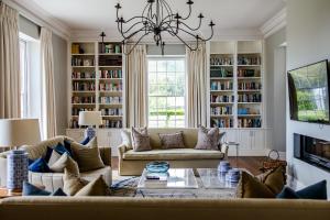 a living room with a couch and a chandelier at Brookdale Estate - Manor House in Paarl