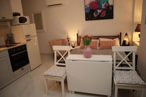 a kitchen with a table with a vase of flowers on it at "Art Studio" Old Town Rovinj-Holiday in Rovinj