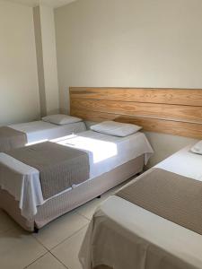 Un pat sau paturi într-o cameră la Pousada Maanaim