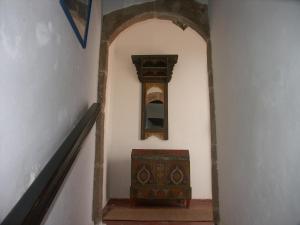 a stairway leading to a room with a clock on it at Dar Ness in Essaouira