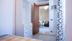 a bedroom with a bed and a dresser and a mirror at Lighthouse Ladispoli al mare in Ladispoli