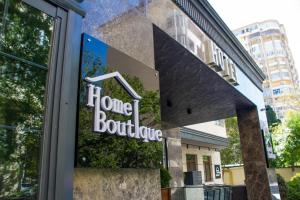 a store window with the sign for home boutique at Home Boutique Hotel in Baku
