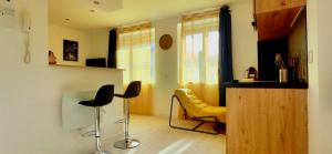 a living room with two chairs and a yellow chair at Citizenhouse - Gare in Valenciennes