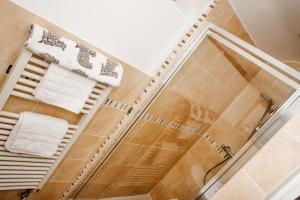 a bathroom with a shower and a towel rack at Elegant Georgian Grade II Listed House full of charm - 3 Super king rooms - 3 Mins for Safari Park & Steam Train - Parking in Bewdley