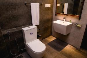a bathroom with a white toilet and a sink at Venus Heaven Luxurious Villa in Tangalle +96 photos