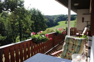 un balcón con mesa y sillas en el porche en Ferienwohnung Katja, en Wilnsdorf