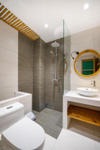 une salle de bain avec toilettes, lavabo et miroir dans l'établissement Carol Villa Đà Nẵng Beach 1, à Đà Nẵng 25 autres photos