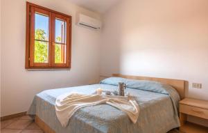 a bedroom with a bed with a sink and a window at Trilo 6 in Budoni