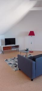 a living room with a couch and a table at La plage in Audierne
