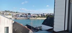 a view of a body of water from a window at La plage in Audierne