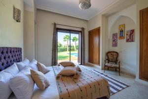 a living room with a large white couch and a chair at Villa Selma avec piscine chauffée in Marrakesh +73 photos