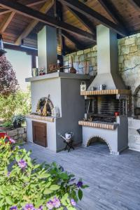 an outdoor kitchen with an outdoor oven in a patio at Ambelaki Polythea in Kardhoulianós