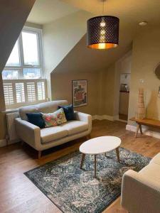 a living room with a couch and a table at Keeper's Rest in Cromer