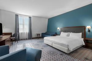 a bedroom with a large bed and a blue wall at Radisson Blu Hotel Wroclaw in Wrocław