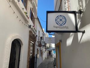 a sign hanging on the side of a building at Vagamundos in Tarifa +58 photos