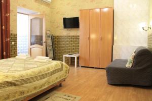 a bedroom with a bed and a chair and a cabinet at Apartment on Mira 4/1 in Kislovodsk