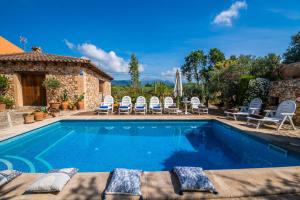 a swimming pool with chairs and a house at Ideal Property Mallorca - Villa Erika in Inca