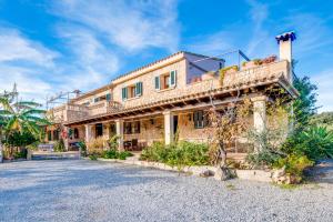 a house with a balcony on top of it at Ideal Property Mallorca - Can Carabassot in Pollença
