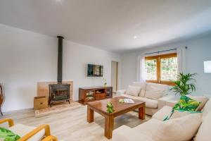 a living room with a couch and a fireplace at Ideal Property Mallorca - Sa Vinya Vella in Alcudia