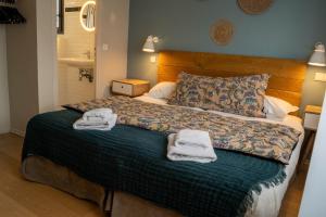 Una cama o camas en una habitación de Logis Hôtels - Le Belvédère - Hôtel 2 étoiles et Restaurant