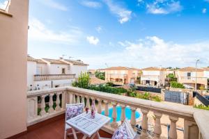 einen Balkon mit Blick auf den Pool und die Gebäude in der Unterkunft Ideal Property Mallorca - Son Moleto in Sa Ràpita