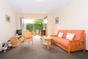 a living room with a couch and a table at Ferienwohnung Riegstra in Esens