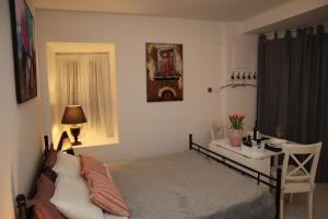 a bedroom with a bed and a table and a desk at "Art Studio" Old Town Rovinj-Holiday in Rovinj