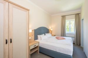 Voodi või voodid majutusasutuse Inselhotel Faakersee toas