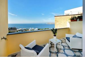 a balcony with a view of the ocean on a building at Terra Murata Boutique b&b in Procida