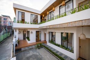 a house with white walls and windows and a courtyard at Carol Villa Đà Nẵng Beach 1 in Danang