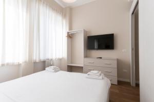 Televízia a/alebo spoločenská miestnosť v ubytovaní Via Torino Apartment 3
