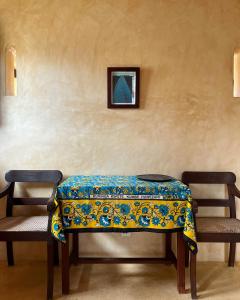 
a wooden bench sitting in a room next to a wall at Subira House in Lamu

