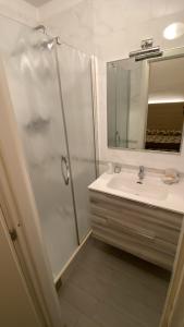 a bathroom with a shower, sink, and mirror at Hotel Holiday in Bologna