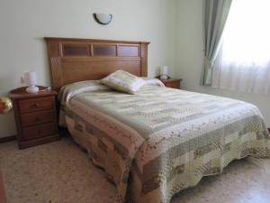 a bedroom with a bed and a dresser and a window at Apartamento Fanals in Lloret de Mar +17 photos