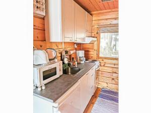 a kitchen with a sink and a microwave at Holiday Home Pajuranta by Interhome in Oravi