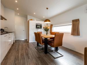a kitchen and dining room with a table and chairs at Holiday Home Green Resort Mooi Bemelen-1 by Interhome in Bemelen