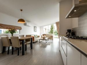 una cucina e un soggiorno con tavolo in legno e sala da pranzo di Holiday Home Green Resort Mooi Bemelen by Interhome a Bemelen