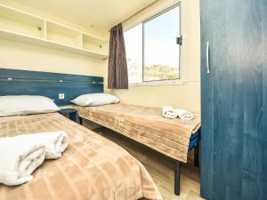 Cette chambre comprend 2 lits et une fenêtre. dans l'établissement Holiday Home Palma-4 by Interhome, à Obrovac