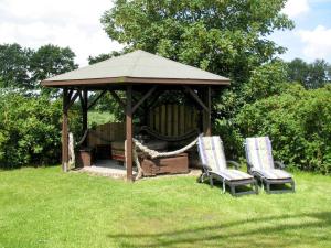two chairs and a gazebo in the grass at Holiday Home Sielmühle by Interhome in Middelsbur