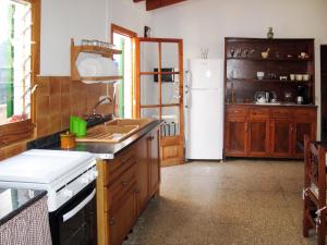 a kitchen with a sink and a refrigerator at Holiday Home Sa Caseta by Interhome in Cala Santanyi