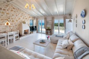 a living room with a couch and a fireplace at Waterfalls in Gaios
