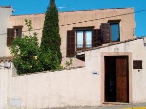 a building with a door and a tree at Holiday Home Maria Fumet - CDE160 by Interhome in Capdepera
