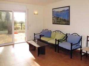 a living room with a couch and a table at Holiday Home Bretos 8 - CGE 215 by Interhome in Fonts