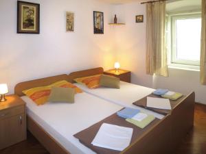 a bedroom with a large bed with two pillows at Holiday Home Helena - Pag310 by Interhome in Pag