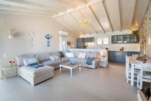 a living room with a couch and a table at Waterfalls in Gaios