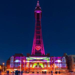 a tower lit up in pink at night at Bel Reve Hotel in Blackpool