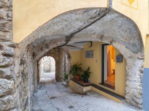 an archway in a stone building with a potted plant at Apartment Le Volte - PTB190 by Interhome in Pietrabruna