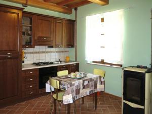 a kitchen with a table and chairs in it at Holiday Home Il Casello by Interhome in Sillano