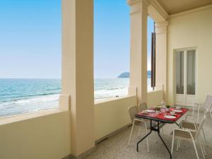 a dining room with a table and a view of the ocean at Apartment Terrazza sul molo by Interhome in Alassio